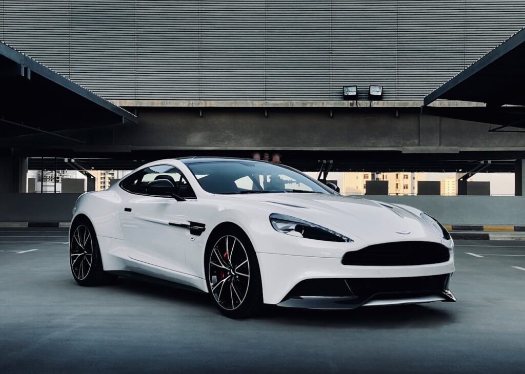 A sleek white sports car parked in a modern urban environment, showcasing elegance and design.
